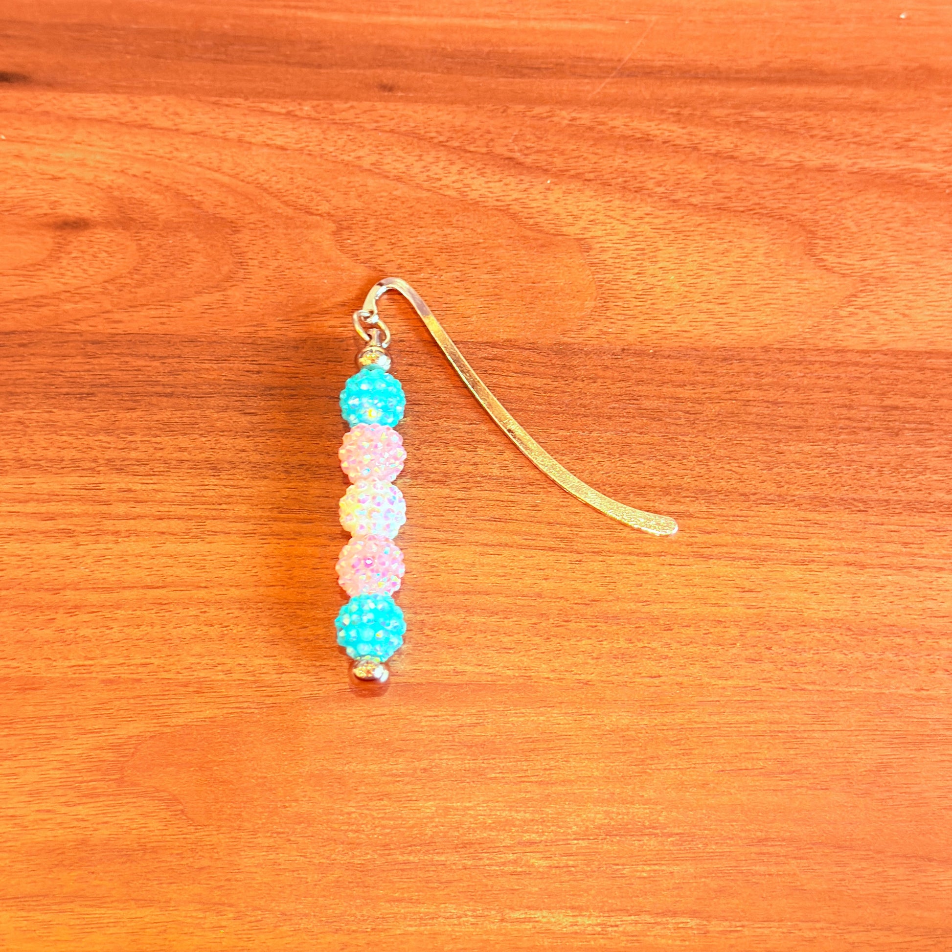 Blue pink and white rhinestone beads on a bookmark
