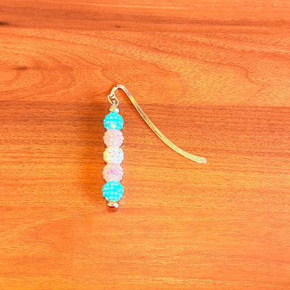 Blue pink and white rhinestone beads on a bookmark